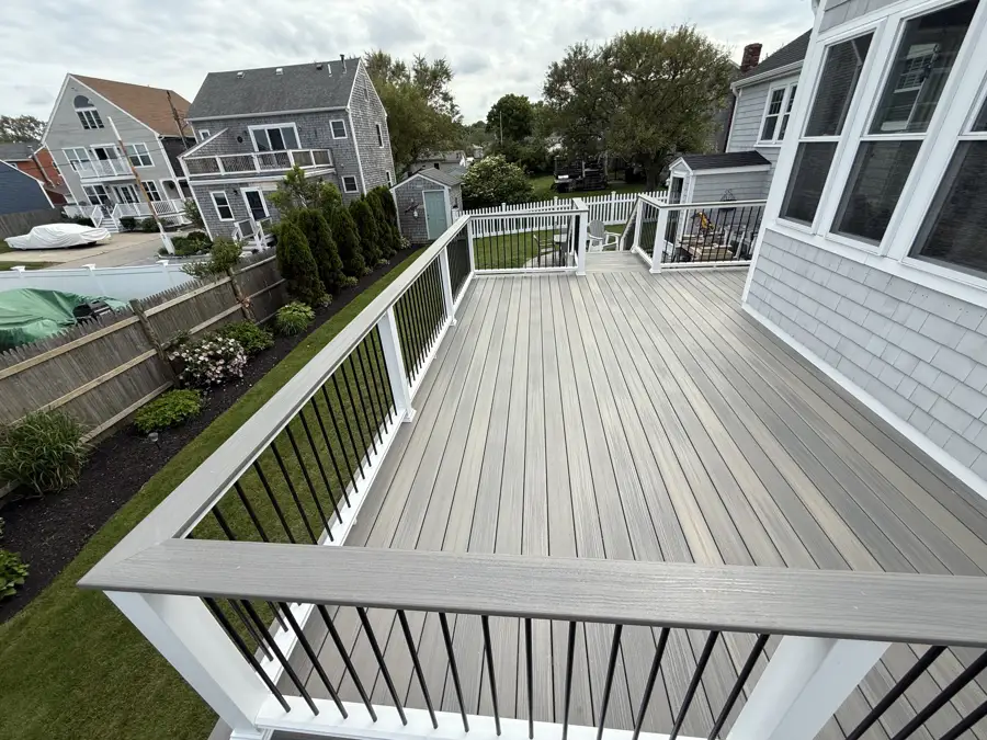 New deck with white railing and black balusters