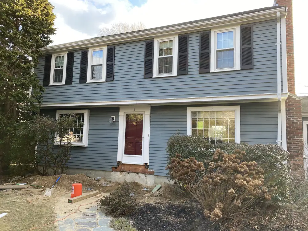 Blue colonial with a new red entry door
